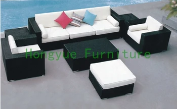 Brown rattan garden sofa with colorful cushions